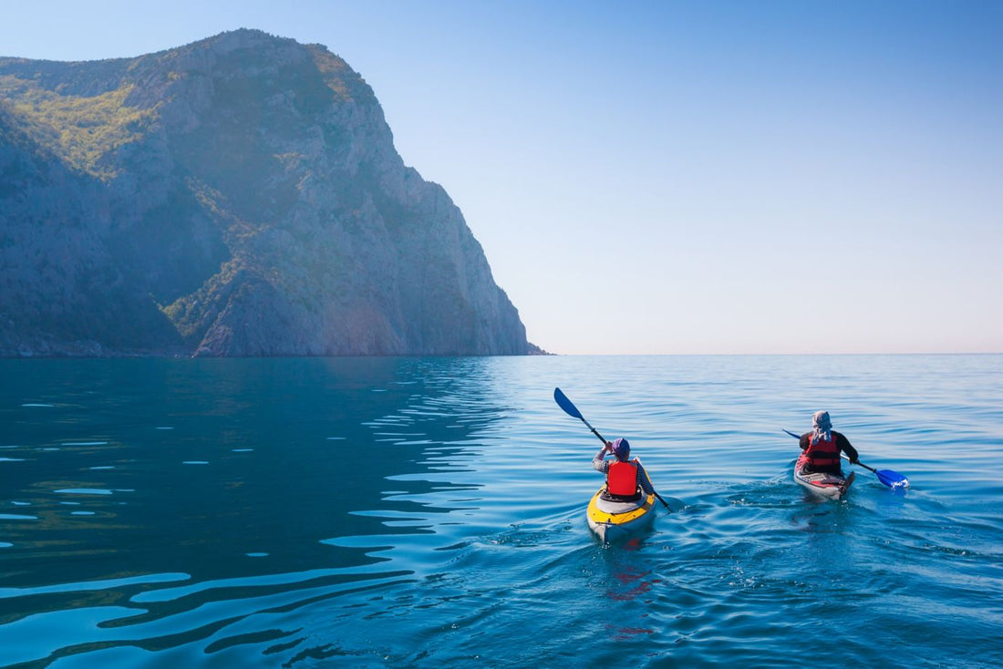 Kayaking in the sea from back view